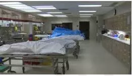 Morgue  - (A place where bodies are kept, especially to be identified or claimed.)