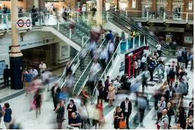 Bustling  - (Move in an energetic or noisy manner.)