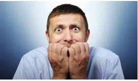 Ill at ease - Nervous or anxious.