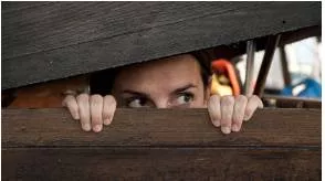 Lurk - To hide somewhere, usually with the intention to do something bad.