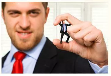 Cockily - Meaning: In an overconfident manner that annoys other people.
