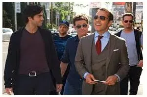 Entourage  - A group of people attending or surrounding an important person.