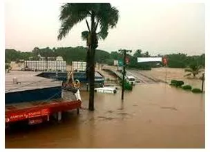 Inundation  - The fact of large amounts of water covering an area that is usually dry.