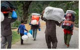 Trudge  - Walk slowly and with heavy steps, typically because of exhaustion or harsh conditions.