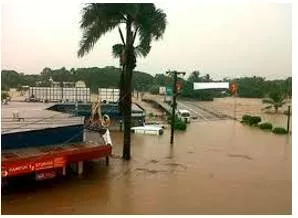 Inundation  - The fact of large amounts of water covering an area that is usually dry.