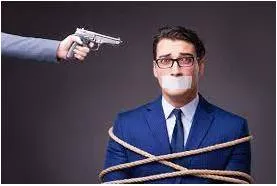 Hostage  - A person who is captured and held prisoner by a person or group, and who may be injured or killed if people do not do what the person or group is asking.