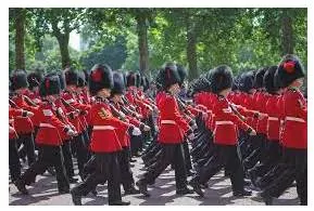 Marching - Walk in a military manner with a regular measured tread.