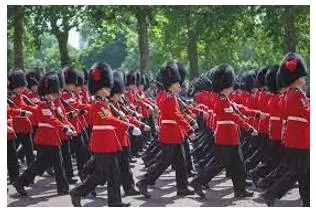 Marching - Walk in a military manner with a regular measured tread.