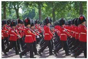 Marching - Walk in a military manner with a regular measured tread.