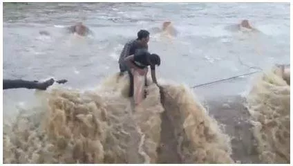 Watch  teens stuck for an hour in overflowing river in udaipur  rescued