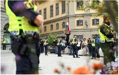 Two men set fire to koran during protest outside swedish parliament