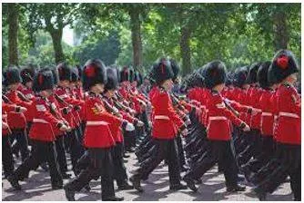 Marching - Walk in a military manner with a regular measured tread.