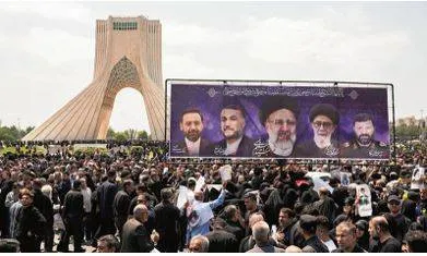 Huge crowds gather in iran’s capital for president’s funeral