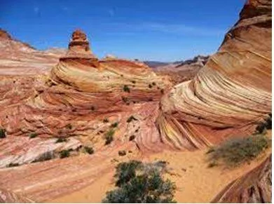 Eroded - Gradually wear away (soil, rock, or land). (घिस)