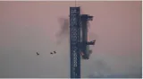 In a first  spacex successfully 'catches' megarocket booster after test flight
