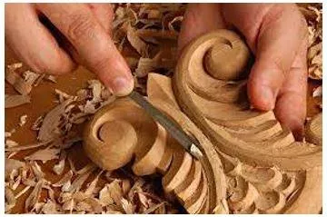 Carving - An object or design carved from a hard material as an artistic work. (नक्काशी)