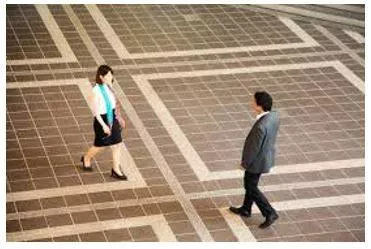 Hovering - To stand somewhere, especially near another person, eagerly or nervously waiting for their attention.