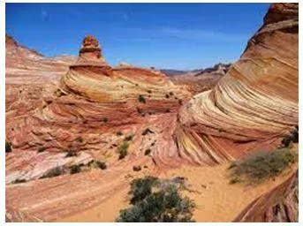 Eroding - Gradually wear away (soil, rock, or land). (घिस)