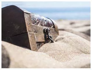 Buried - Covered or hidden, often by being placed under the ground or another surface. (दफन किया हुआ)