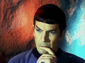 Intriguingly - In a manner that arouses one's curiosity or interest.