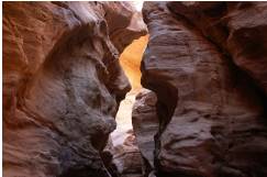 Chink  - A small narrow crack or opening.
