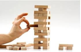 Precarious  - Unstable, dangerous or difficult.