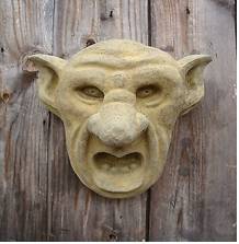Grotesque  - A very ugly or comically distorted figure or image.