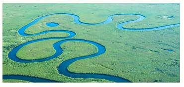 Meander  - Meaning: (of a river or road) follow a winding course.
