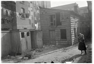 Tenements  - Meaning- A large building divided into flats, especially in a poor area of a city.