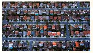 Sprawling  - Meaning- Spreading in an untidy way.