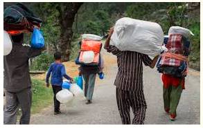 Trudge  - Meaning- Walk slowly and with heavy steps, typically because of exhaustion or harsh conditions.