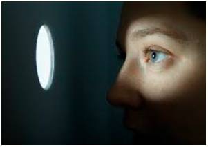 Lurk  - To wait somewhere secretly, especially because you are going to do something bad or illegal.