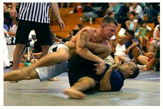 Grapple  - Struggle to deal with or overcome (a difficulty or challenge).