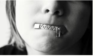 Reticence  - A dislike of telling people about things.