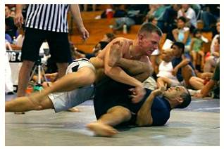 Grapple  - Struggle to deal with or overcome (a difficulty or challenge).