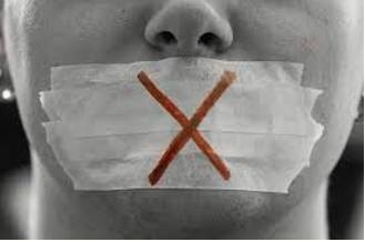 Gag  - Prevent (someone) from speaking freely or disseminating information.