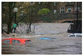 Inundated  - To cover an area of land with a large amount of water