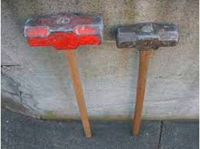Sledgehammer - a large heavy tool with a long handle and a metal block at one end, used for breaking rocks, etc.