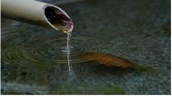 Trickle  - To flow, or to make something flow, slowly in a thin stream.