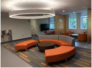 Lounge  - A room for waiting in at an airport, etc.