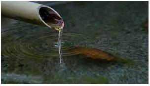 Trickle  - To flow, or to make something flow, slowly in a thin stream.