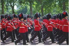 Marching - Walk in a military manner with a regular measured tread.