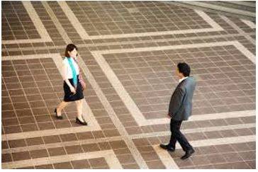 Hovering - To stand somewhere, especially near another person, eagerly or nervously waiting for their attention.