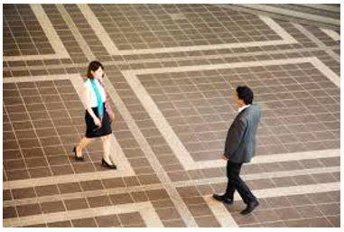 Hovering - To stand somewhere, especially near another person, eagerly or nervously waiting for their attention.
