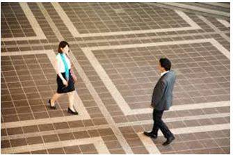 Hovering - To stand somewhere, especially near another person, eagerly or nervously waiting for their attention.