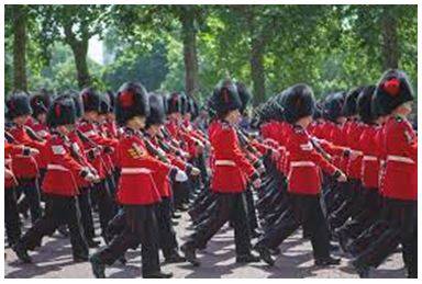 Marching - Walk in a military manner with a regular measured tread.