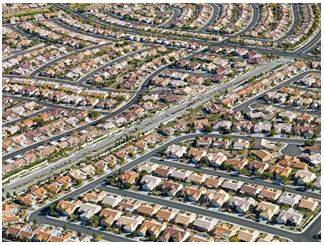 Sprawling - Spreading out over a large area in an untidy or irregular way.